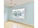 Bedroom featuring bright blue paint, a chandelier, and a large window offering ample light at 8608 Talbert Paige Ct, Charlotte, NC 28277