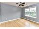 Bedroom features a ceiling fan and natural light from a large window at 8608 Talbert Paige Ct, Charlotte, NC 28277