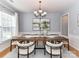 Elegant dining room with a wooden table, comfortable seating, and stylish lighting at 8608 Talbert Paige Ct, Charlotte, NC 28277