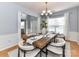 Bright dining room featuring a wooden table, comfortable seating, and modern decor at 8608 Talbert Paige Ct, Charlotte, NC 28277
