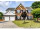 Charming two-story brick home with a well-manicured lawn and inviting curb appeal at 8608 Talbert Paige Ct, Charlotte, NC 28277