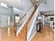 Welcoming foyer featuring a staircase, hardwood floors, and easy access to main living spaces at 8608 Talbert Paige Ct, Charlotte, NC 28277