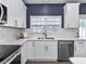Well-lit kitchen features white cabinets, stainless steel appliances and subway tile backsplash at 8608 Talbert Paige Ct, Charlotte, NC 28277