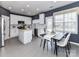 Modern kitchen features white cabinets, stainless steel appliances, gray tile floors and an island at 8608 Talbert Paige Ct, Charlotte, NC 28277