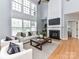 Bright living room boasts a fireplace, large windows, and hardwood floors, creating an inviting space at 8608 Talbert Paige Ct, Charlotte, NC 28277