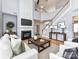 Open-concept living room features a fireplace, staircase, and hardwood floors for an inviting atmosphere at 8608 Talbert Paige Ct, Charlotte, NC 28277