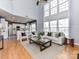 Open-concept living room with a high ceiling, large windows, and hardwood floors at 8608 Talbert Paige Ct, Charlotte, NC 28277
