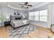 Spacious main bedroom with tray ceiling, ceiling fan, and large windows at 8608 Talbert Paige Ct, Charlotte, NC 28277