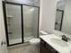 Modern bathroom featuring gray tile shower with glass door, vanity and toilet at 9108 Dulwich Dr # Ken0074, Charlotte, NC 28215