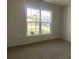 Cozy bedroom featuring neutral carpet and a large window with neighborhood views at 9108 Dulwich Dr # Ken0074, Charlotte, NC 28215