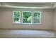 Sunny bedroom with a large window with a picturesque view of lush trees at 9108 Dulwich Dr # Ken0074, Charlotte, NC 28215
