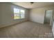 Bright bedroom features neutral carpet, large window, and a walk-in closet at 9108 Dulwich Dr # Ken0074, Charlotte, NC 28215
