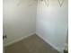 Walk-in closet features neutral carpet and metal shelving at 9108 Dulwich Dr # Ken0074, Charlotte, NC 28215