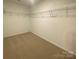 Walk in closet with wire shelving and neutral carpet at 9108 Dulwich Dr # Ken0074, Charlotte, NC 28215