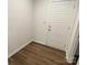 Entryway features wood floors and a white front door at 9108 Dulwich Dr # Ken0074, Charlotte, NC 28215
