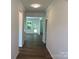 Bright hallway with elegant trim and hardwood floors leading to sunlit rooms in the home at 9108 Dulwich Dr # Ken0074, Charlotte, NC 28215
