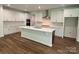 Spacious kitchen featuring an island, stone countertops, stainless steel appliances, and ample cabinet space at 9108 Dulwich Dr # Ken0074, Charlotte, NC 28215