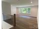 Spacious living room features wood-look floors and large windows for ample natural light at 9108 Dulwich Dr # Ken0074, Charlotte, NC 28215