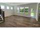 Bright living room with hardwood floors, multiple windows, and easy access to outdoor space at 9108 Dulwich Dr # Ken0074, Charlotte, NC 28215