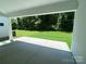 Relaxing covered patio with a view of the expansive, well-maintained backyard lawn and surrounding trees at 9108 Dulwich Dr # Ken0074, Charlotte, NC 28215