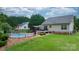 A beautiful backyard featuring a fenced in inground pool, an outdoor deck, gazebo, and lush green lawn at 1028 Pocono Pl, Newton, NC 28658