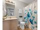 Bathroom featuring flower-designed shower curtain, sink with storage, and tile floors at 1028 Pocono Pl, Newton, NC 28658