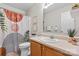 Bright bathroom with modern vanity, decorative mirror and tiled shower with patterned curtain at 1028 Pocono Pl, Newton, NC 28658