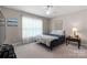 Cozy bedroom featuring natural light, ceiling fan, and quaint side table at 1028 Pocono Pl, Newton, NC 28658
