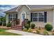 Charming home featuring a cozy front porch, landscaped garden, and a well-maintained lawn at 1028 Pocono Pl, Newton, NC 28658