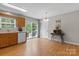 Open-concept kitchen area with light wood cabinetry and access to backyard patio via glass doors at 1028 Pocono Pl, Newton, NC 28658