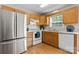 Bright kitchen featuring stainless-steel refrigerator, wood cabinets and white countertops at 1028 Pocono Pl, Newton, NC 28658