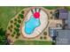 Aerial view of a backyard pool surrounded by a paver patio, lounge chairs, and lush landscaping at 1028 Pocono Pl, Newton, NC 28658