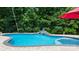 Backyard pool featuring waterfall and decorative statue with tree-lined perimeter at 1028 Pocono Pl, Newton, NC 28658