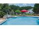 Backyard pool featuring waterfall and decorative statue, red umbrella and chairs at 1028 Pocono Pl, Newton, NC 28658
