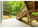 Backyard features stairs up to a deck and a fire pit surrounded by lush trees at 11139 Tradition View Dr, Charlotte, NC 28269