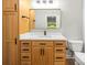 Well-lit bathroom with wood cabinets, modern sink and fixtures, and decorative mirror at 11139 Tradition View Dr, Charlotte, NC 28269