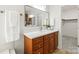 Modern bathroom featuring neutral wood cabinetry, a vanity, mirror, and neutral decor, creating a relaxing oasis at 11139 Tradition View Dr, Charlotte, NC 28269
