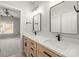 Modern bathroom featuring double sinks, sleek black hardware, and wood cabinetry, leading into a bedroom at 11139 Tradition View Dr, Charlotte, NC 28269