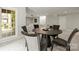 Dining room features a dark round table, seating for four, and view to the living room at 11139 Tradition View Dr, Charlotte, NC 28269
