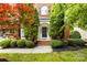 Elegant front entrance with a classic black door, brick steps, and lush green landscaping at 11139 Tradition View Dr, Charlotte, NC 28269