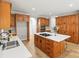 Well-lit kitchen with wood cabinets, a central island cooktop, and sleek countertops at 11139 Tradition View Dr, Charlotte, NC 28269