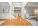 Bright living room featuring hardwood floors, staircase, and a comfortable seating area at 11139 Tradition View Dr, Charlotte, NC 28269