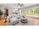Spacious living room featuring hardwood floors, large windows, and a comfortable sectional sofa at 11139 Tradition View Dr, Charlotte, NC 28269