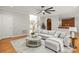 Open living room with hardwood floors, a comfortable sectional sofa, and a view of the staircase at 11139 Tradition View Dr, Charlotte, NC 28269