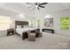 Spacious main bedroom with large bed, sitting area, and natural light from multiple windows at 11139 Tradition View Dr, Charlotte, NC 28269