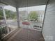 Screened balcony overlooks the street with mature trees, and apartment buildings across the street at 114 Mint Ave # A, Mooresville, NC 28117