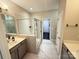 Bright bathroom features a glass enclosed shower, tile floors, and a stylish vanity sink at 114 Mint Ave # A, Mooresville, NC 28117