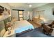 Well-lit bedroom features neutral colors, dark floors, fan, and sliding barn door closet at 114 Mint Ave # A, Mooresville, NC 28117