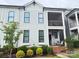 Charming two-story townhome with a screened porch and landscaped front yard at 114 Mint Ave # A, Mooresville, NC 28117