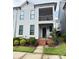 Charming two-story townhome with a screened porch, front entrance, and small front yard at 114 Mint Ave # A, Mooresville, NC 28117